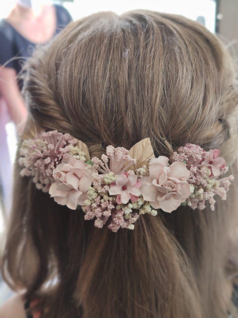 Semirecogido trenzado elegante con adorno floral grande en Peluquería Ana Boiro